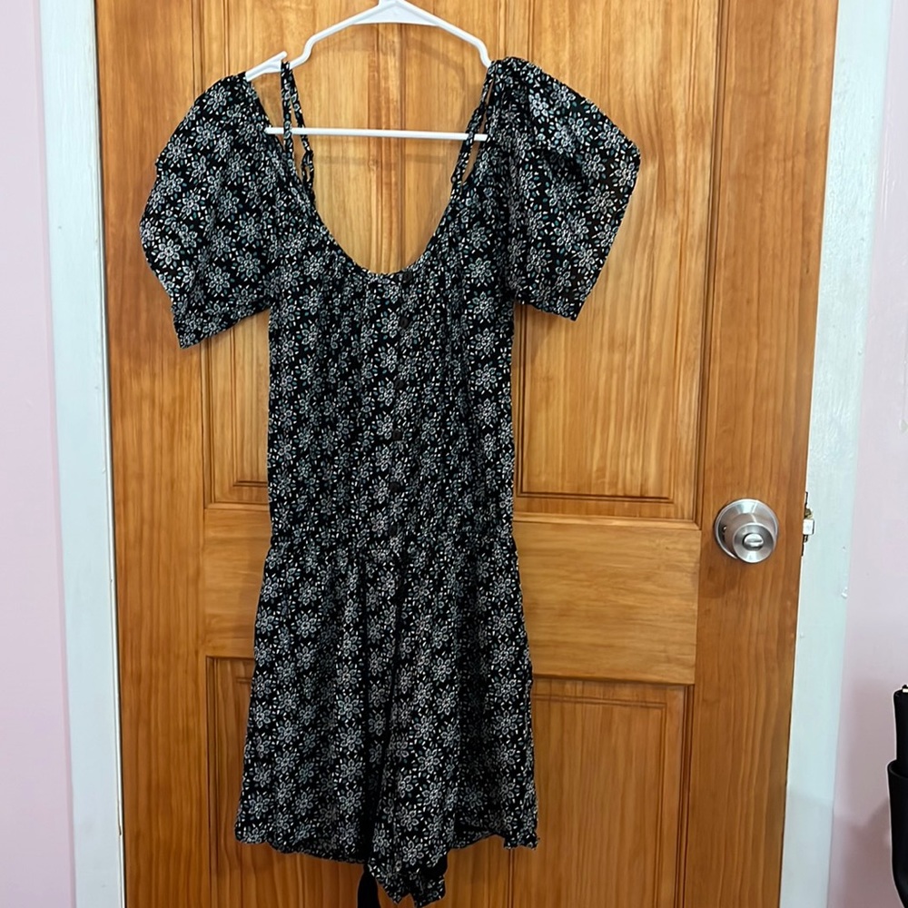 Black romper with a cute green and white pattern.